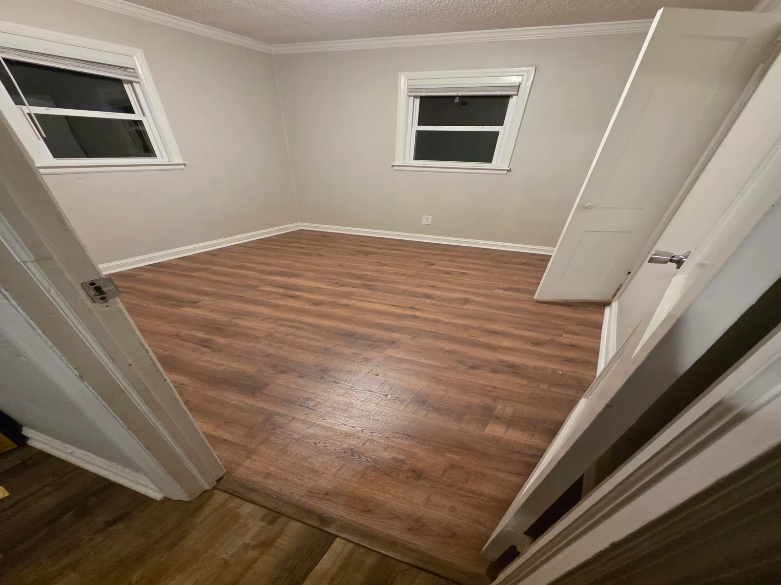 The same room after Firmhand installed new plank flooring, clean and rent-ready